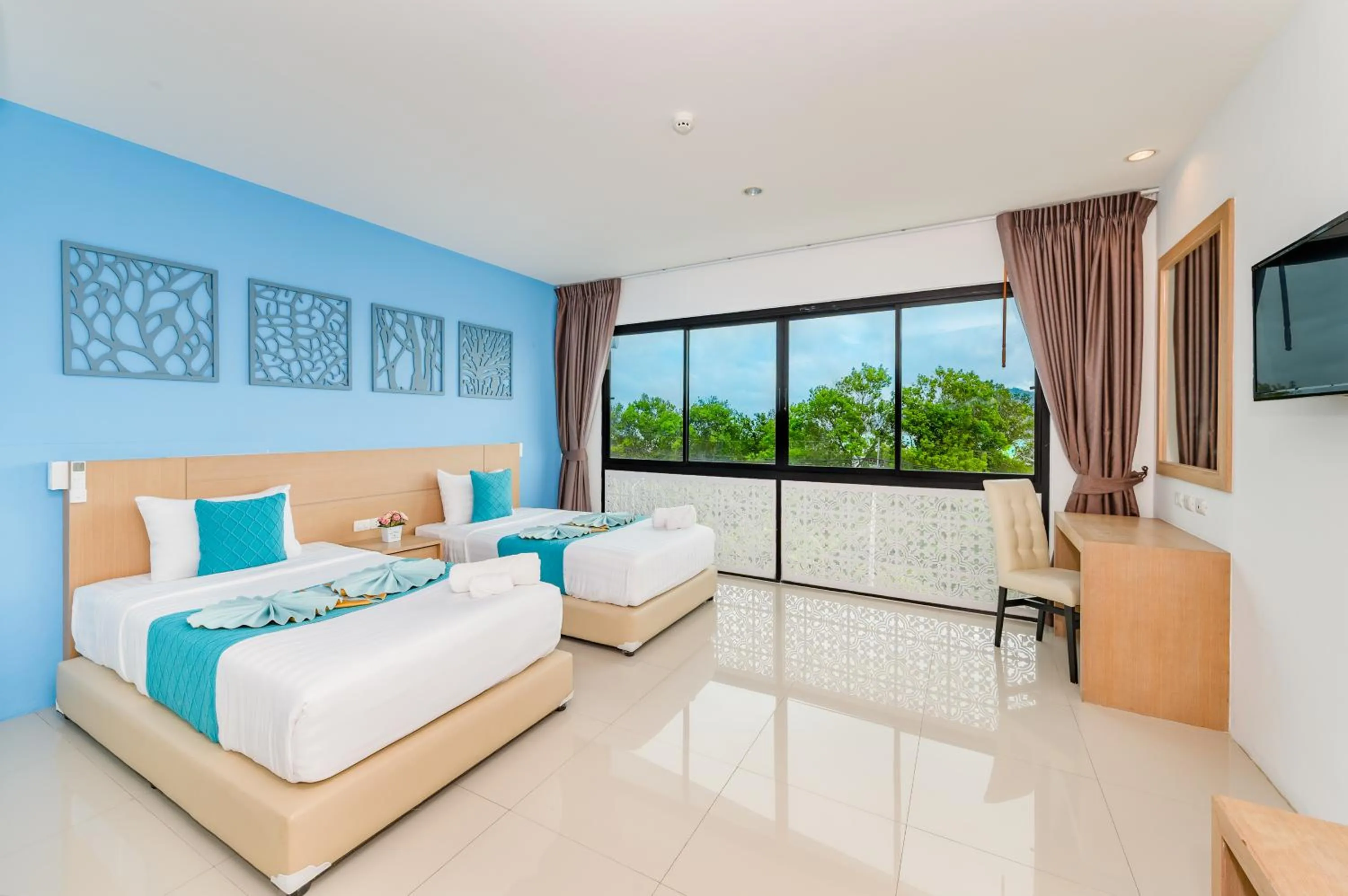 Bed in De Blue Sea Rawai Hotel