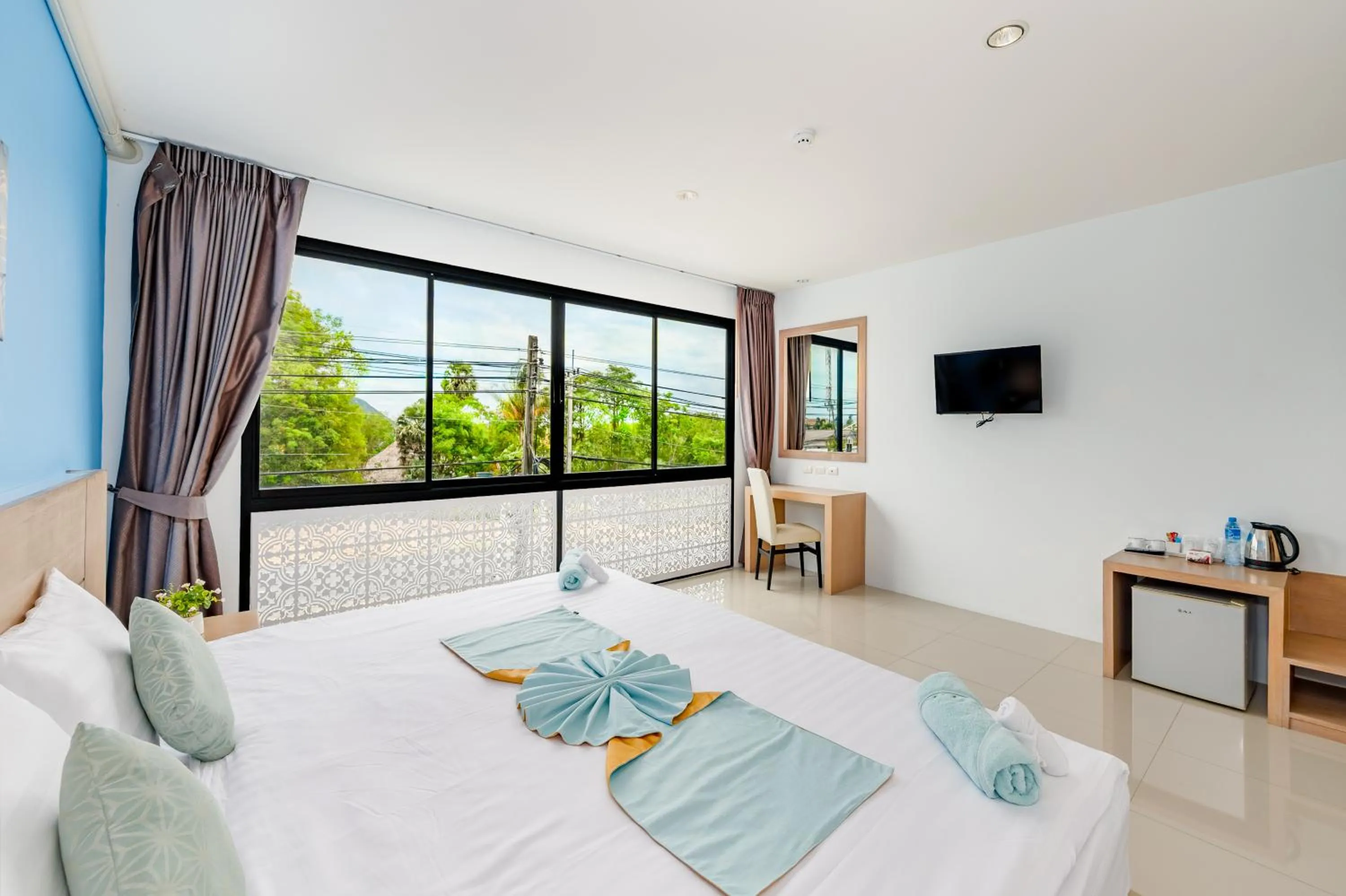 Bed in De Blue Sea Rawai Hotel