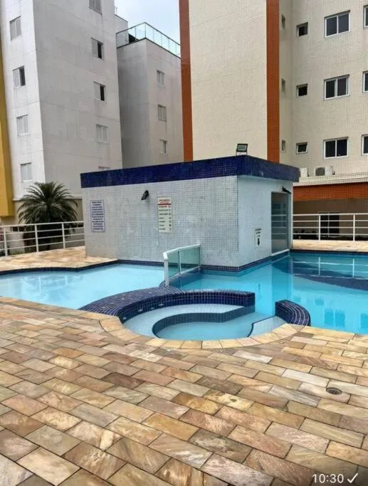 Swimming pool in Apartamento confortável praia grande Ubatuba