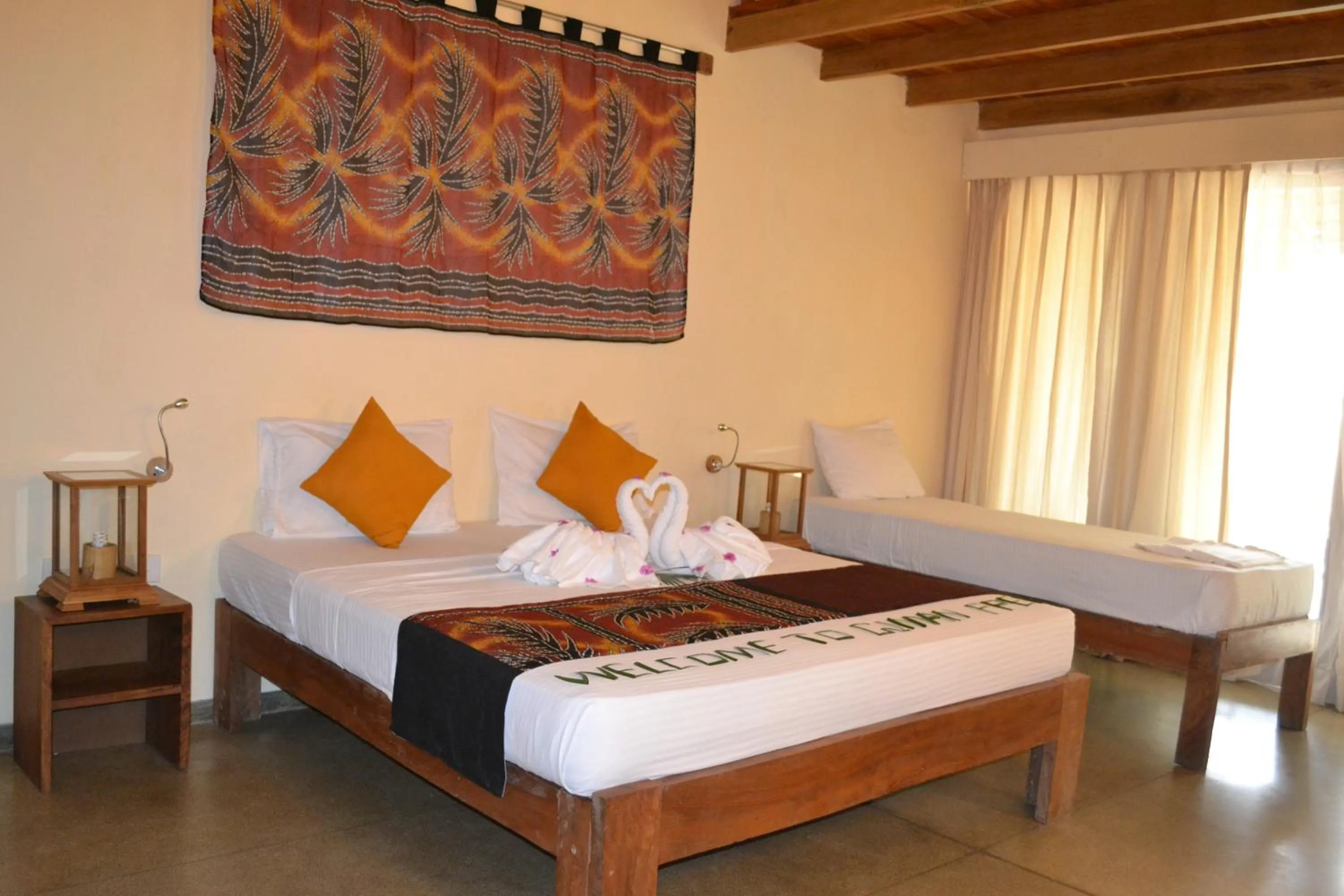 Bed in Giman Free Beach Resort Pasikuda