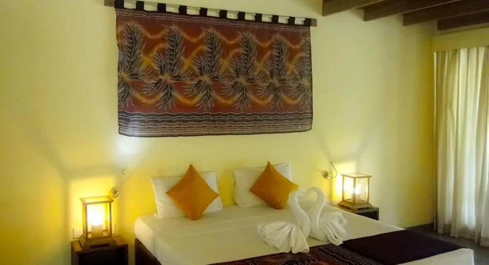 Bed in Giman Free Beach Resort Pasikuda