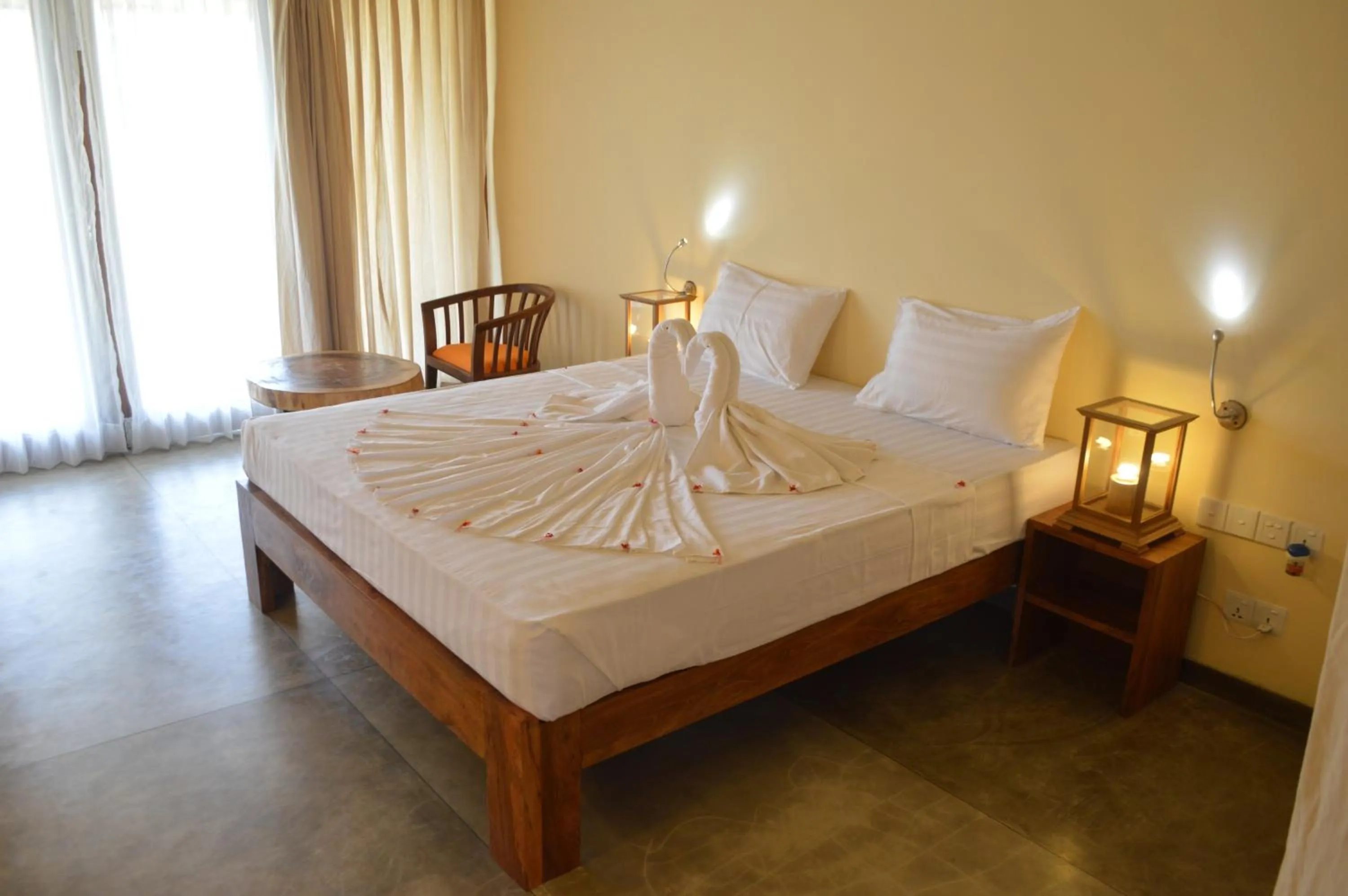 Bed in Giman Free Beach Resort Pasikuda