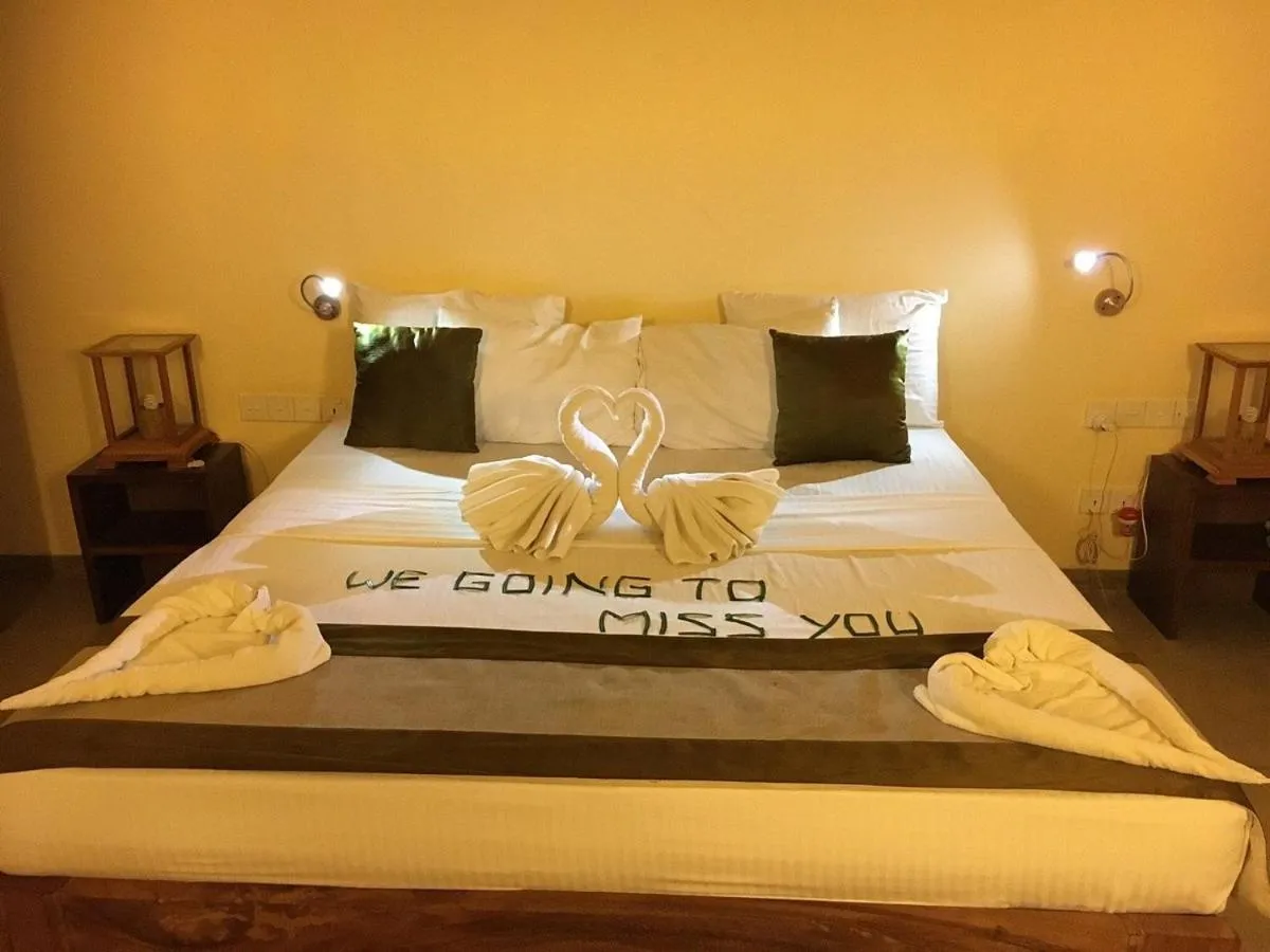 Bed in Giman Free Beach Resort Pasikuda