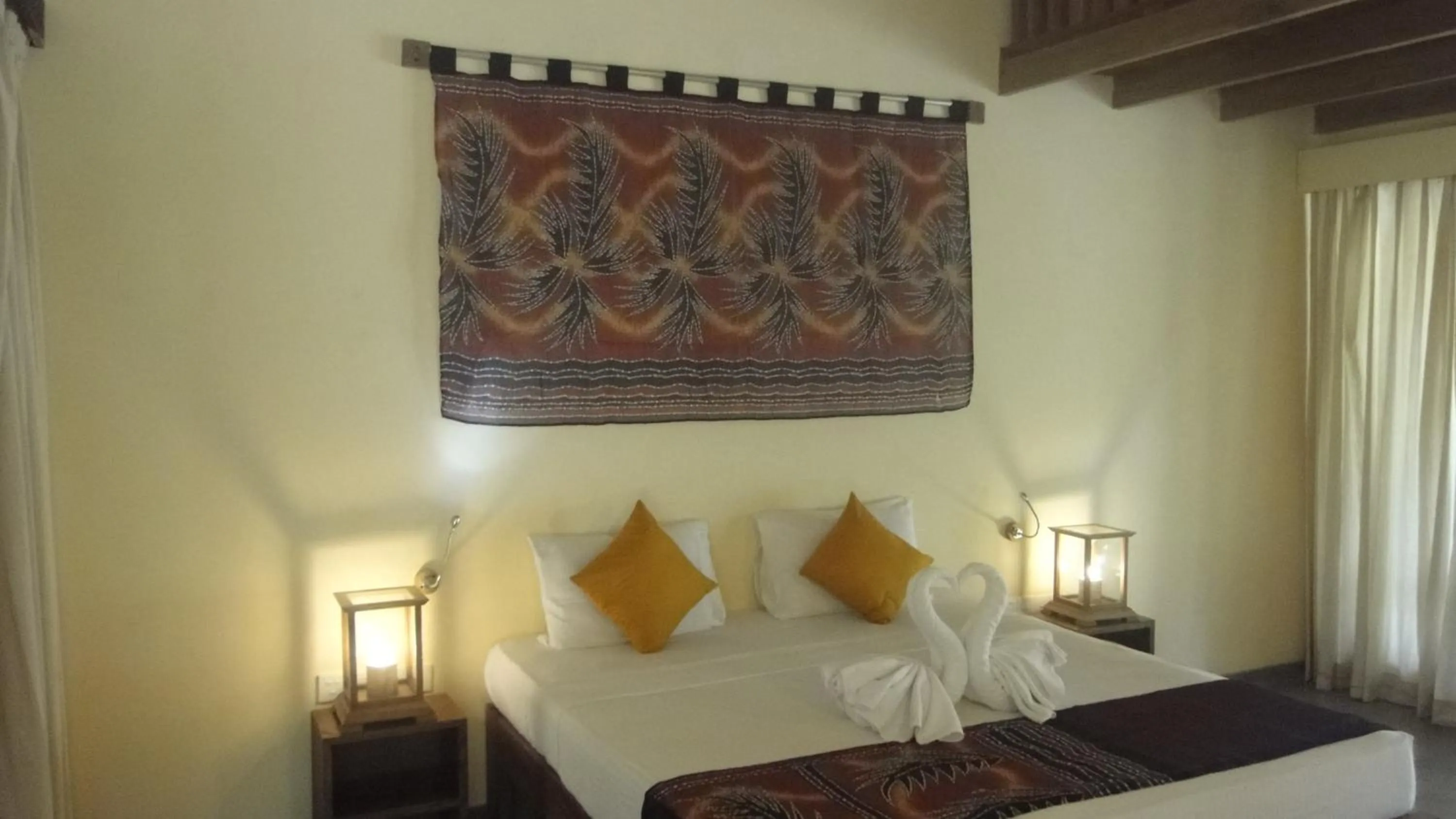 Bed in Giman Free Beach Resort Pasikuda