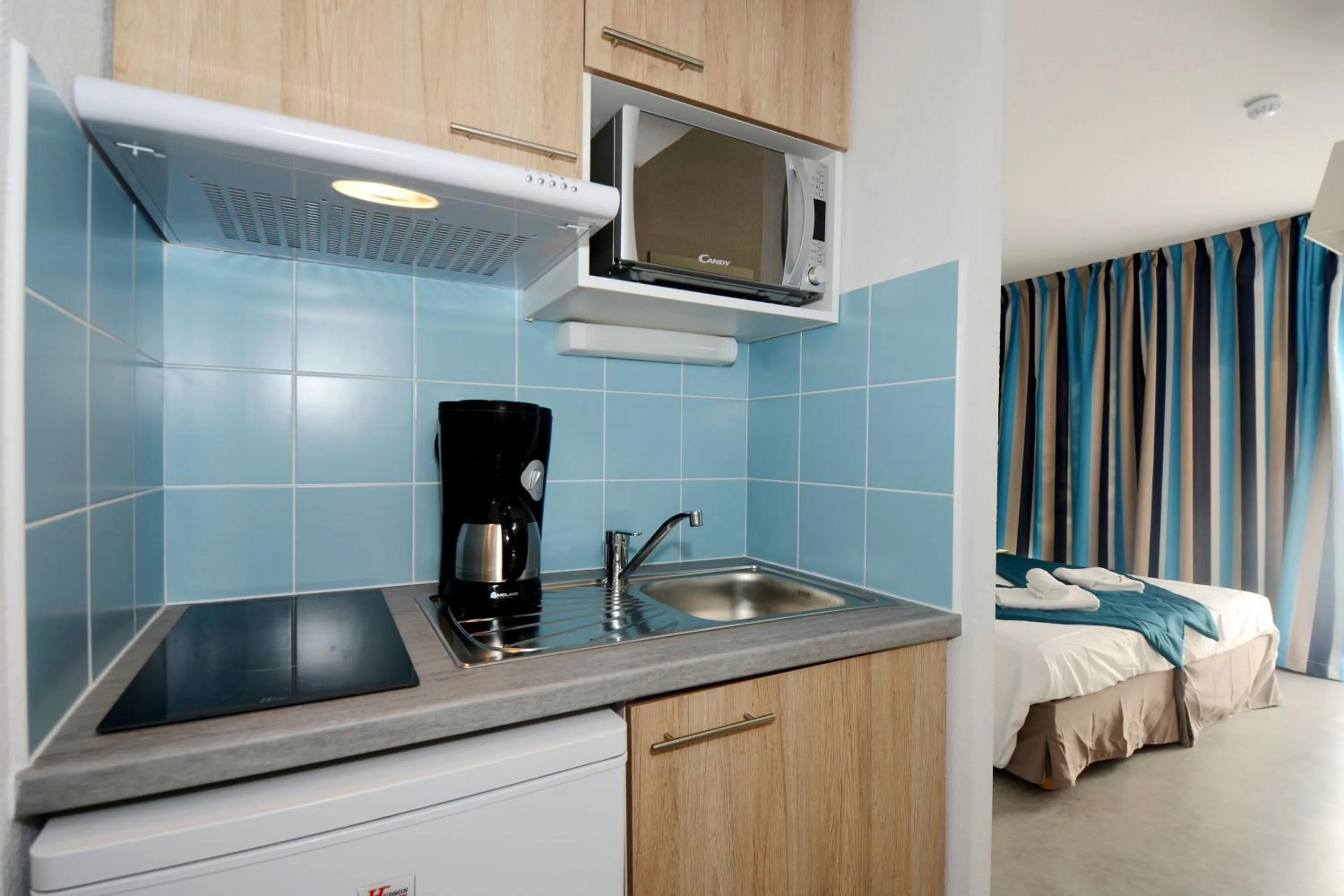 Kitchen or kitchenette, Bed in Appart'Hotel Nakâra by Odalys