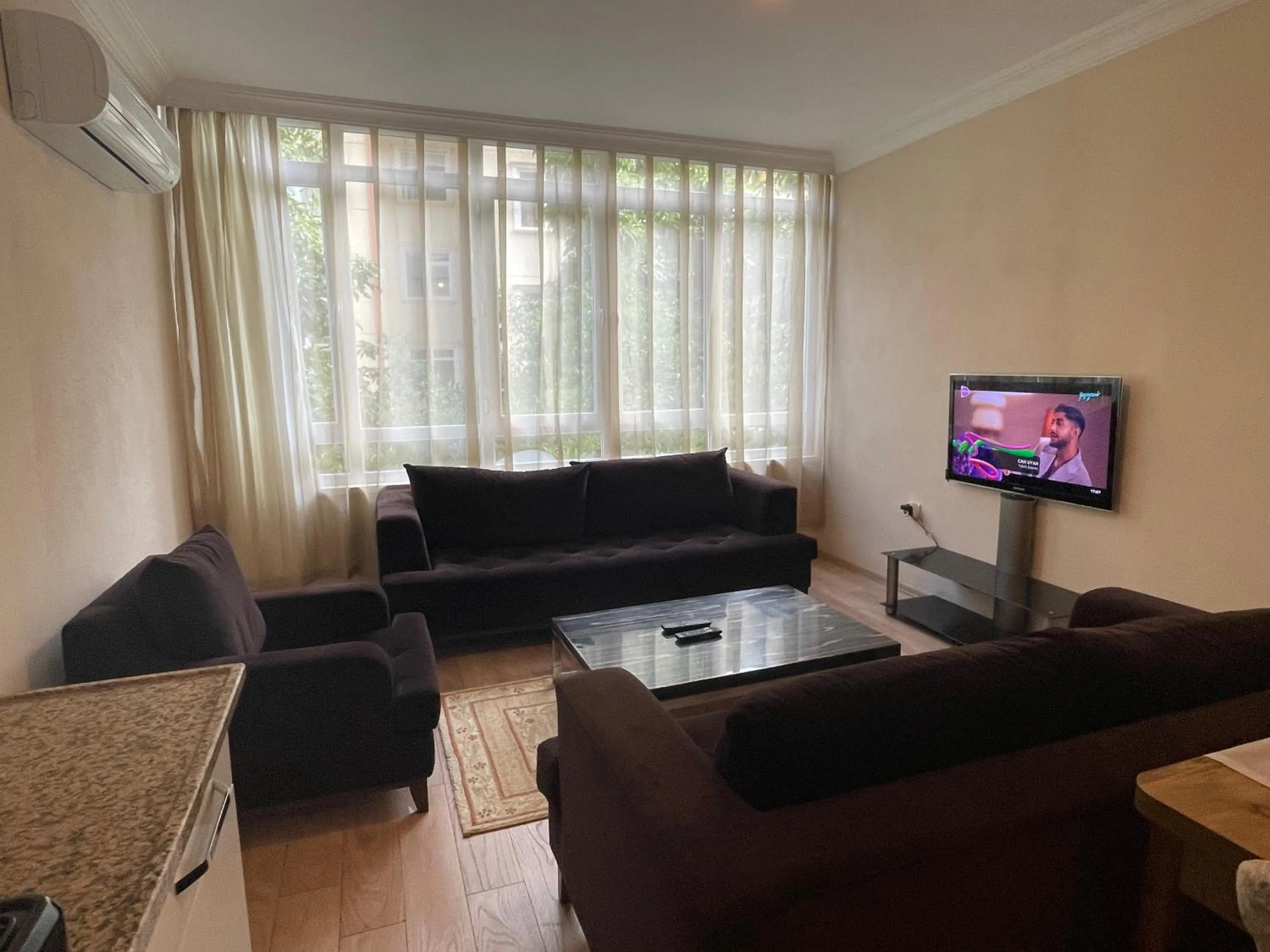 Communal lounge/ TV room in Select Suite & Apart Hotel