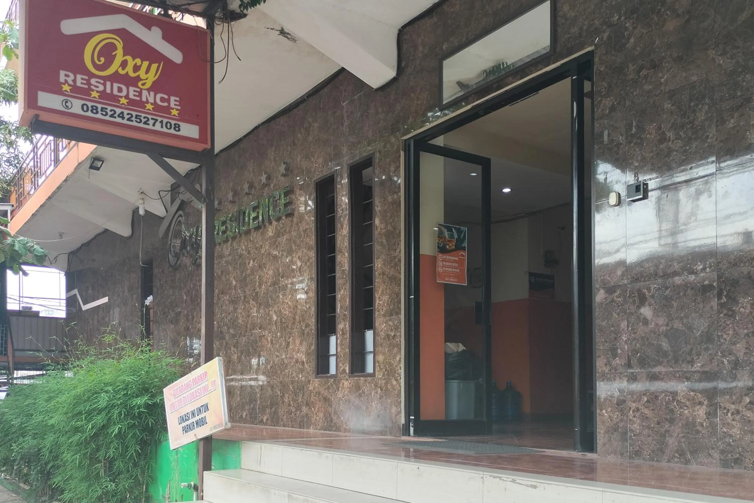 Property logo or sign in RedDoorz at Oxy Residence Manado