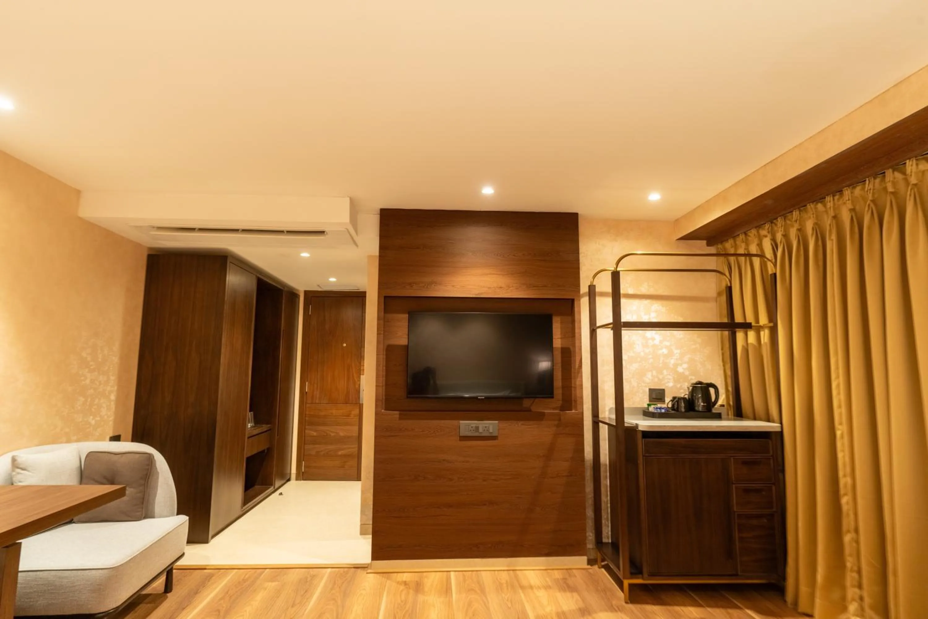 TV and multimedia, Bed in Clarks Inn Suites Hyderabad Airport