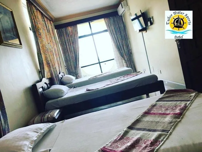 Bed in Tudor Water Sports Hotel