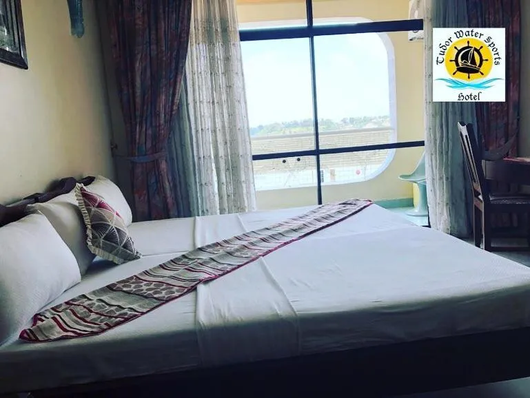 Bed in Tudor Water Sports Hotel