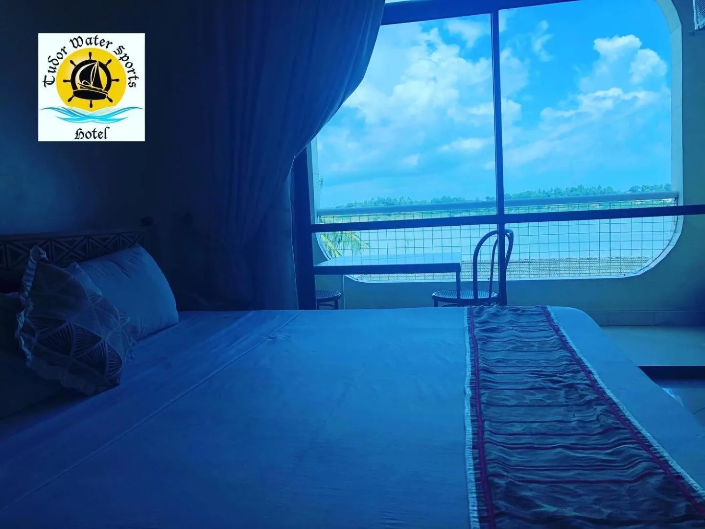 Bed in Tudor Water Sports Hotel