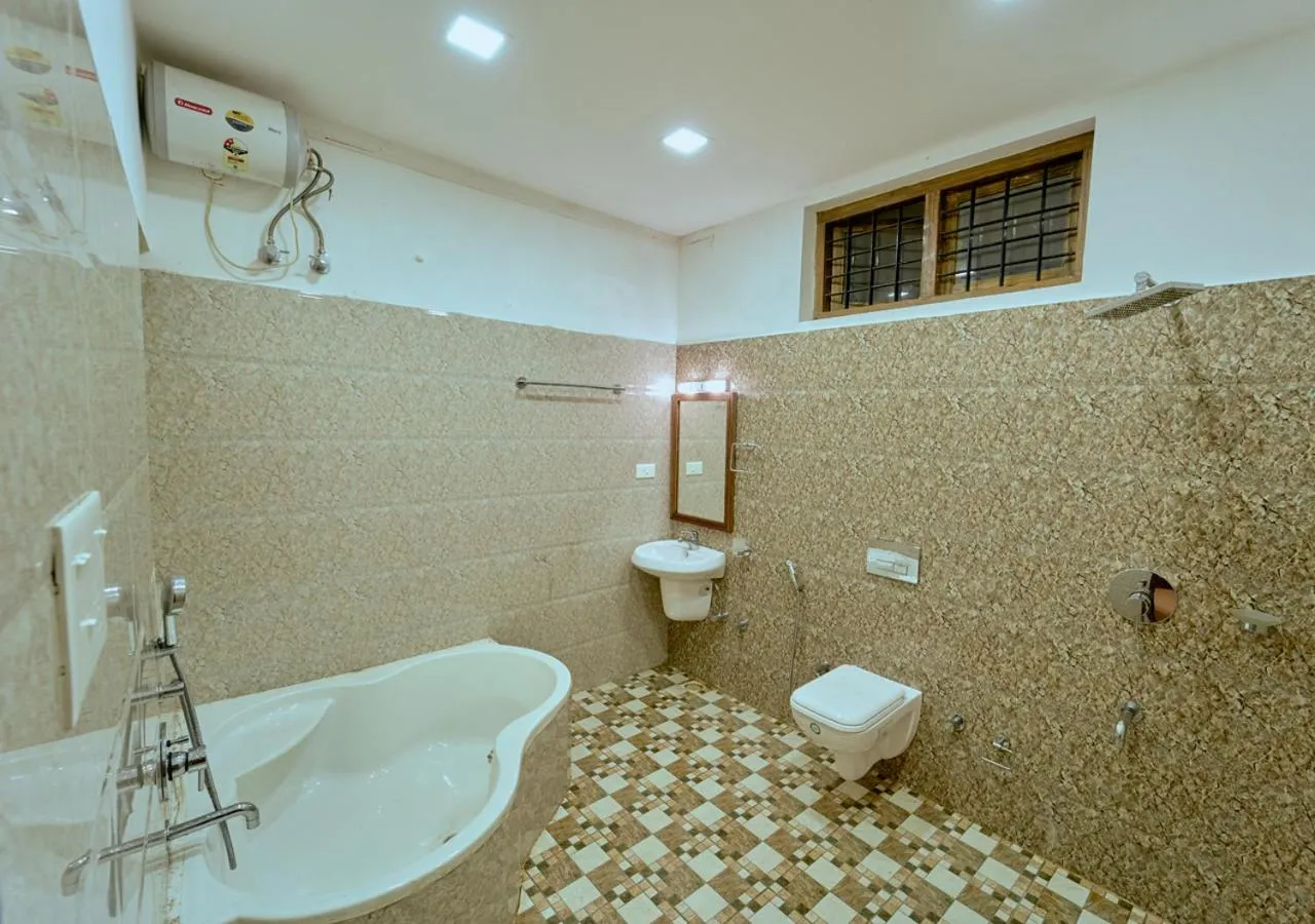 Shower in Ushasree Wayanad Premium Pool Resort by VOYE HOMES