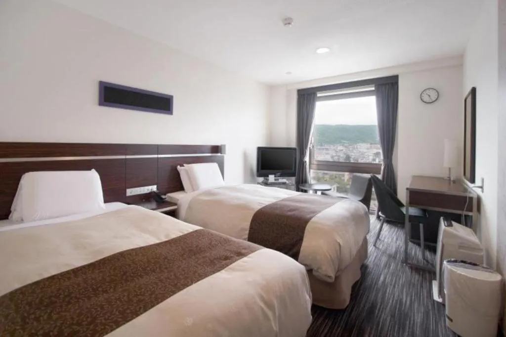 Bed in Hotel Sunroute Kyoto