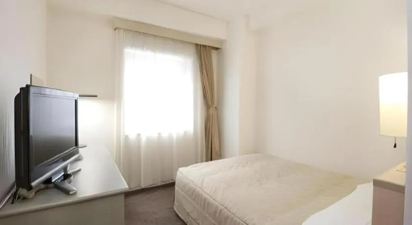 Bed in Hotel Ronshan Sapporo