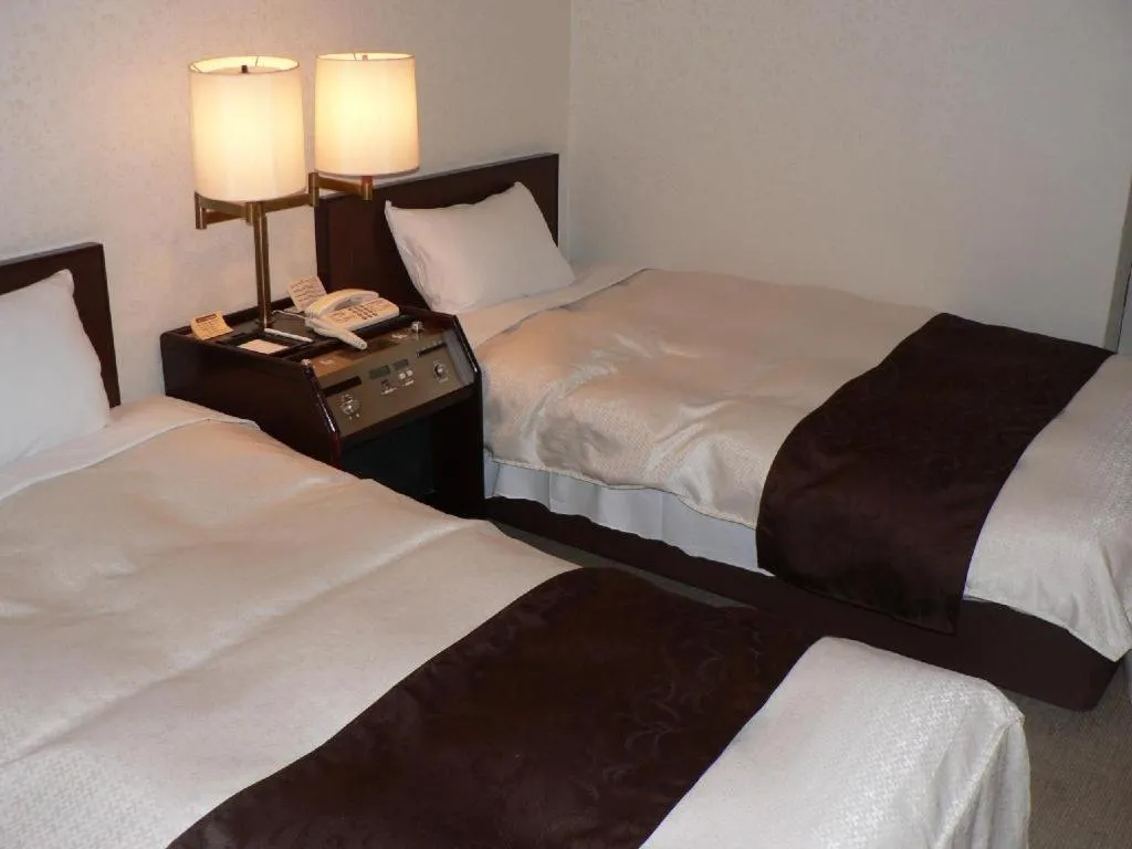 Bed in Hiroshima Kokusai Hotel