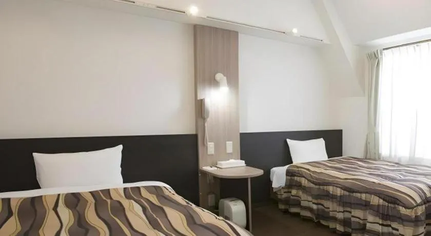 Bed in Hotel Tetora Tsurumi