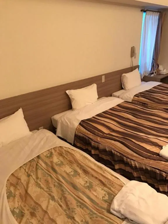 Bed in Hotel Tetora Tsurumi