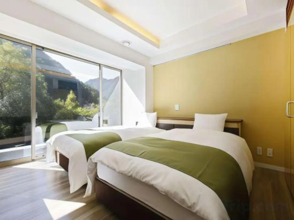 Bed in Hotel Myoken Tanaka Kaikan