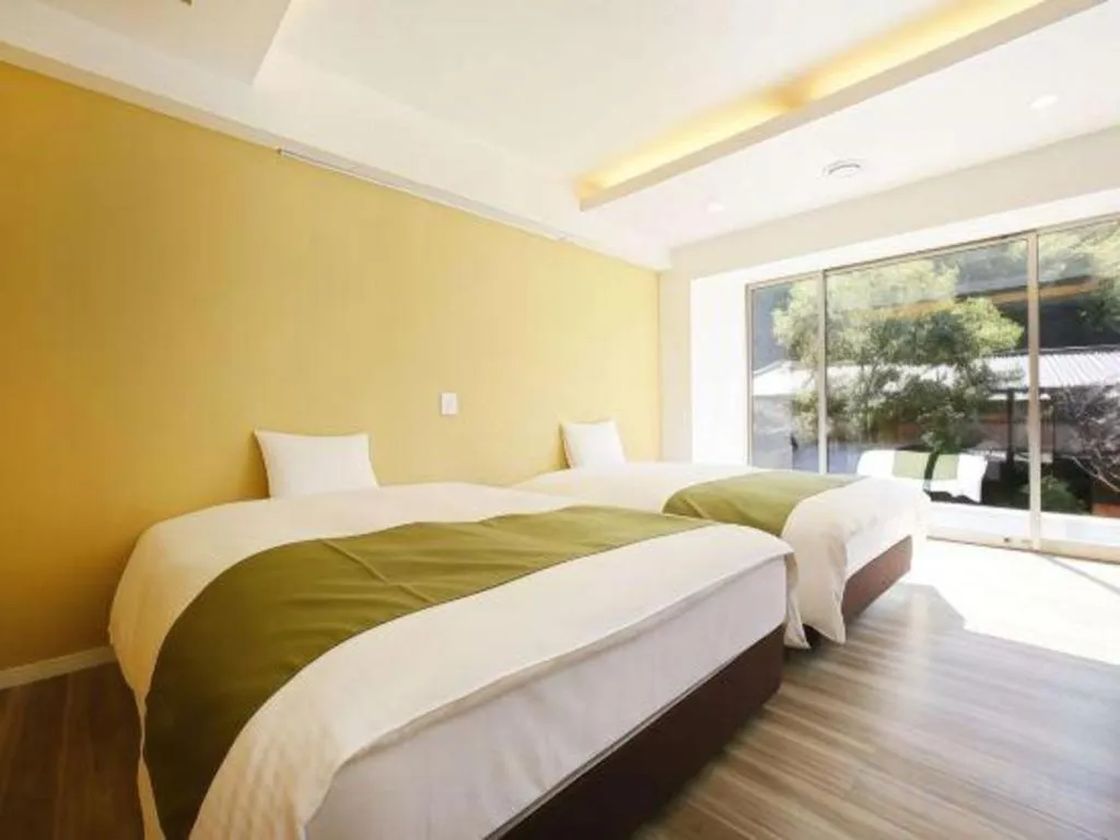 Bed in Hotel Myoken Tanaka Kaikan