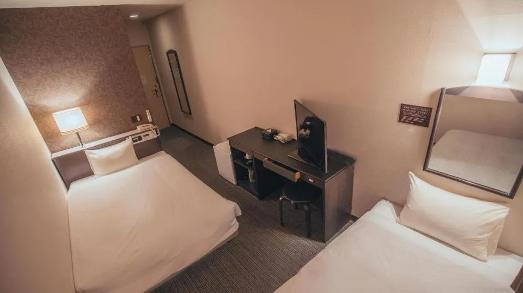 Bed in Hotel AreaOne Miyazaki City