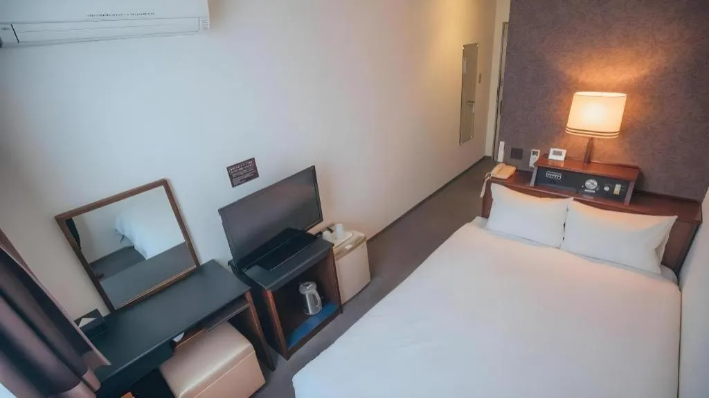 Bed in Hotel AreaOne Miyazaki City