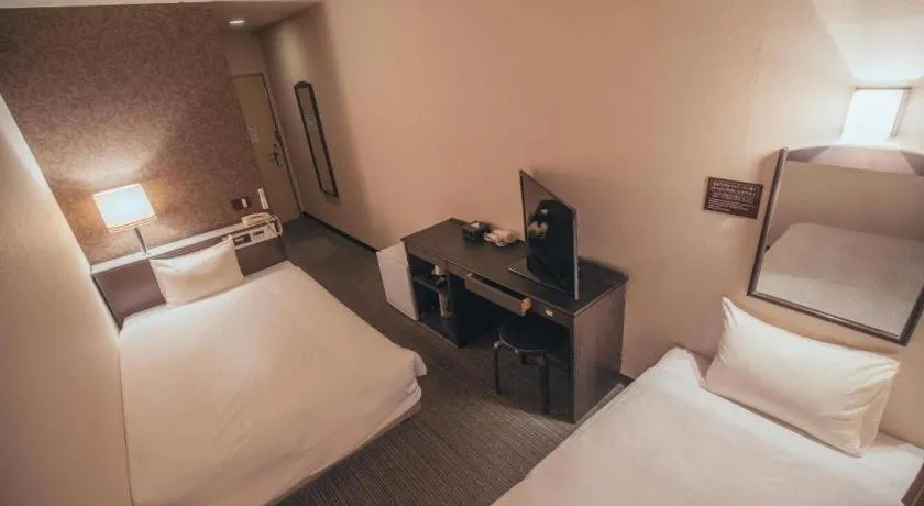 Bed in Hotel AreaOne Miyazaki City