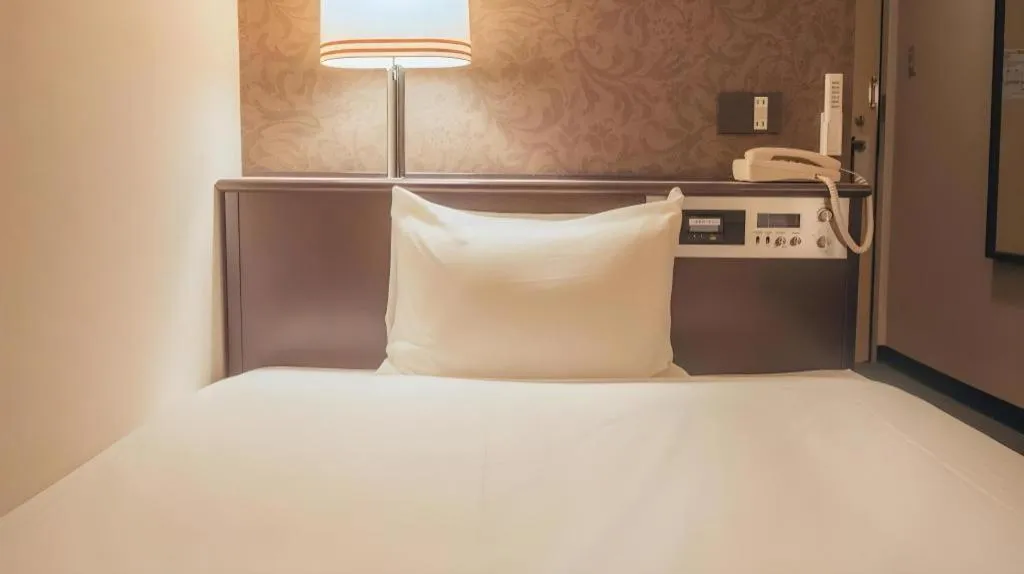 Bed in Hotel AreaOne Miyazaki City