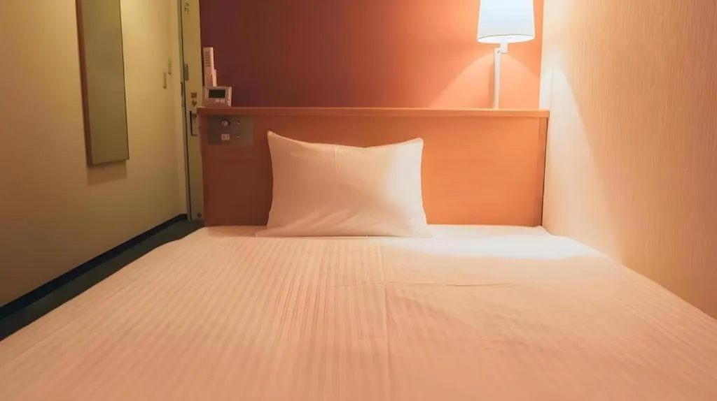 Bed in Hotel AreaOne Miyazaki City