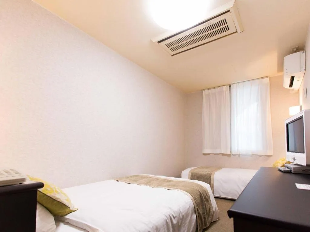 Bed in Hotel AreaOne Miyazaki City