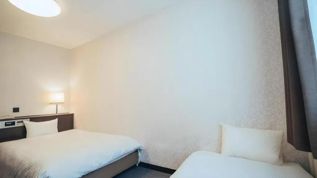 Bed in Hotel AreaOne Miyazaki City