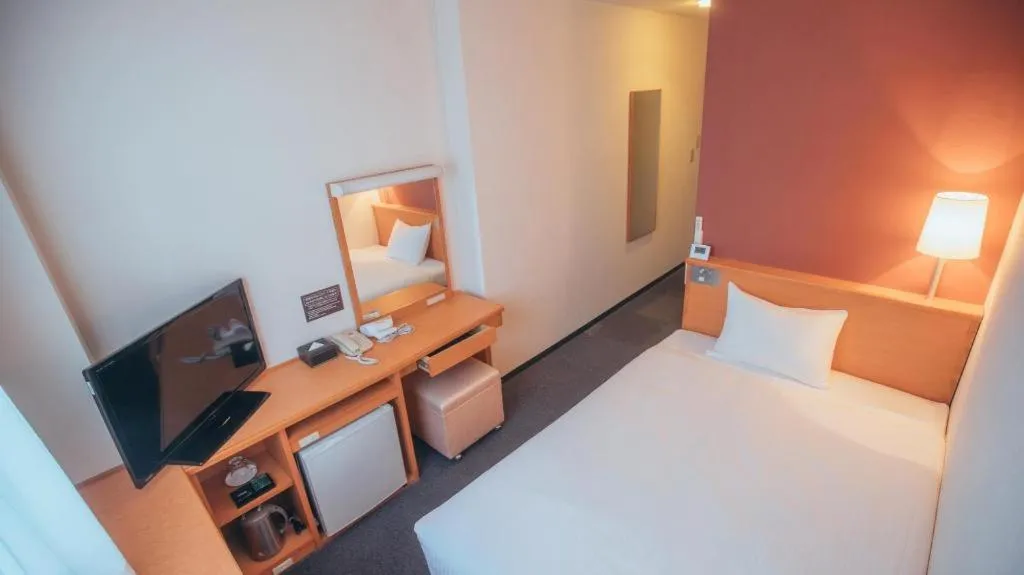 Bed in Hotel AreaOne Miyazaki City