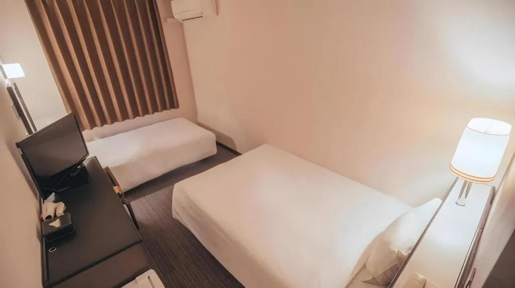 Bed in Hotel AreaOne Miyazaki City