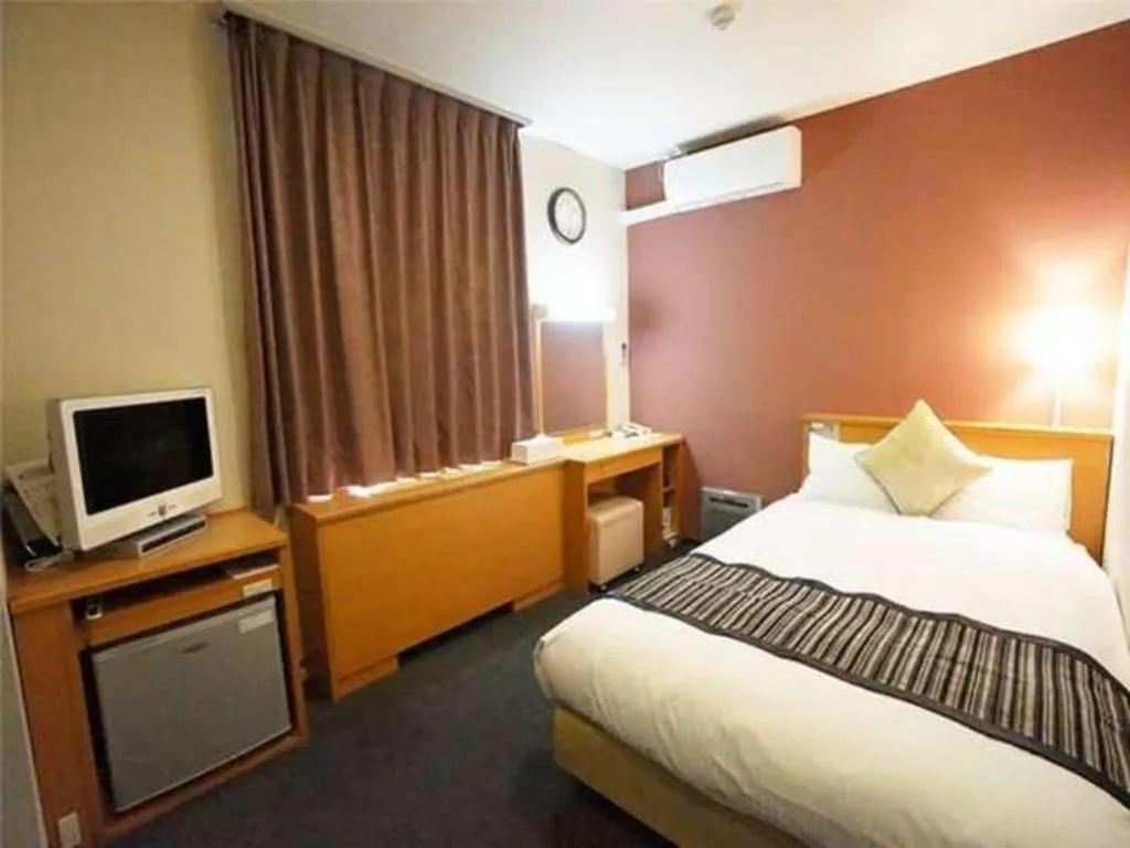 Bed in Hotel AreaOne Miyazaki City