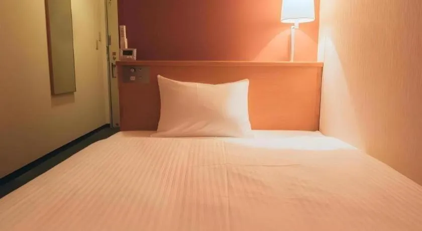 Bed in Hotel AreaOne Miyazaki City