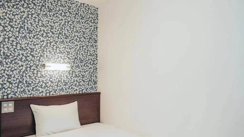 Bed in Hotel AreaOne Miyazaki City