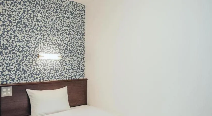 Bed in Hotel AreaOne Miyazaki City