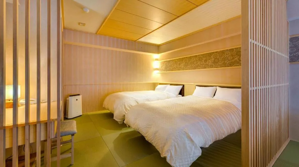 Bed in Shinojima Royal Hotel Kasuisou