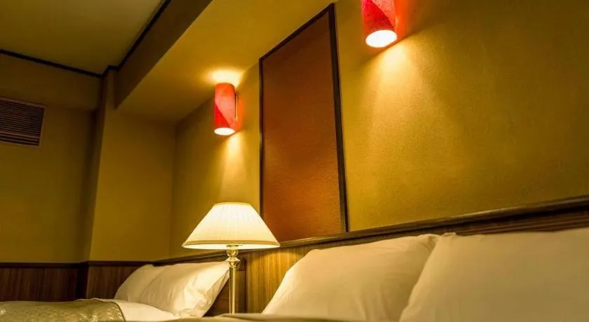 Bed in Shinojima Royal Hotel Kasuisou