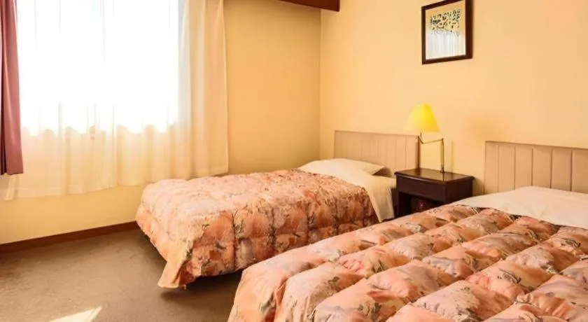 Bed in Ibusuki Onsen Hotel Shougetsu