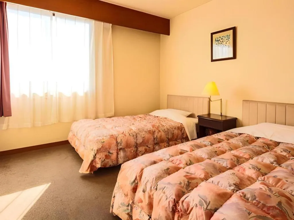 Bed in Ibusuki Onsen Hotel Shougetsu