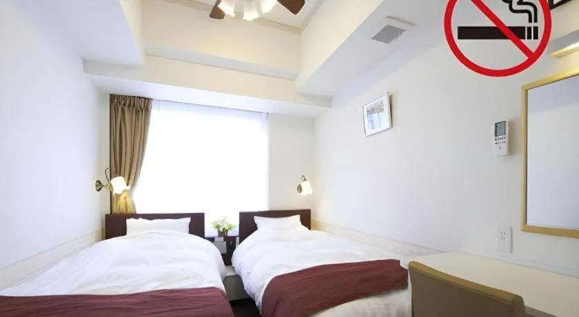 Bed in Hotel Shimbashi Sambankan