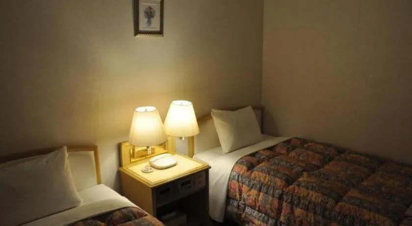 Bed in Palace Inn Toyota