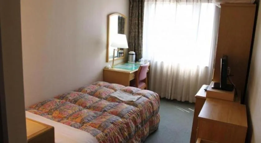 Bed in Palace Inn Toyota