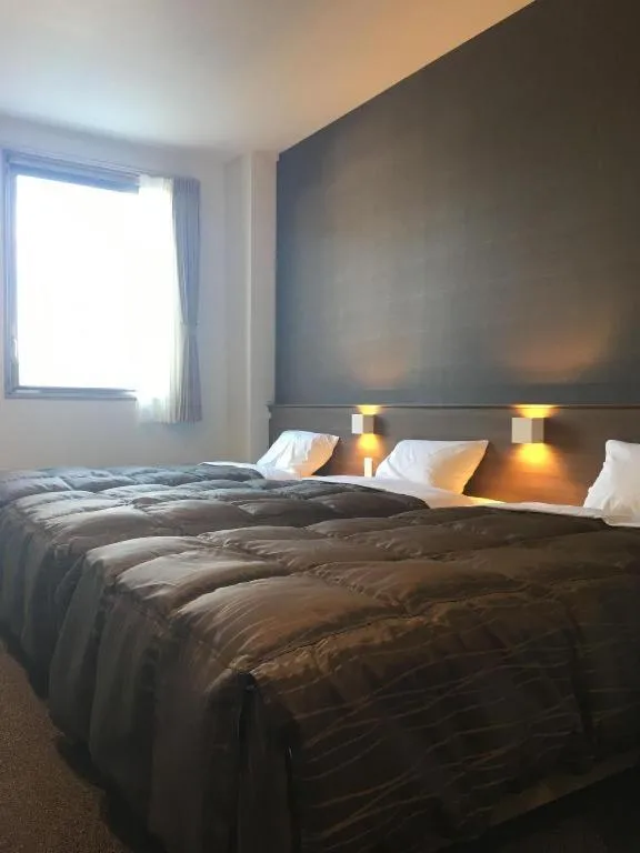 Bed in Daemado Hotel Hitakatsu