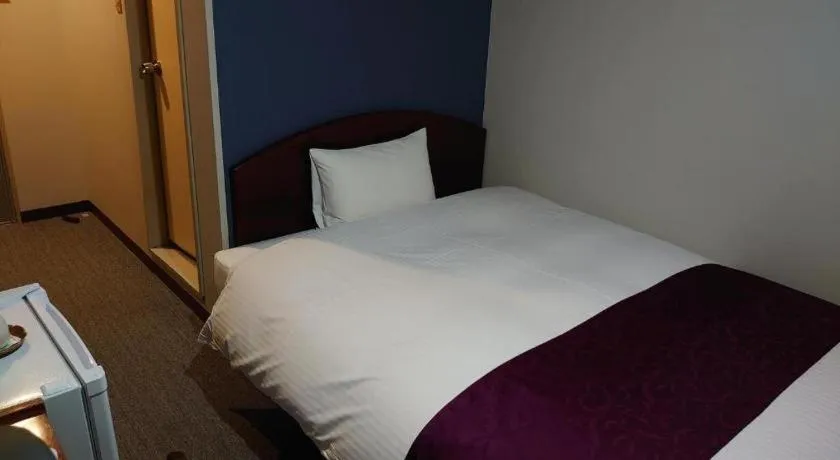 Bed in AKISAWA HOTEL