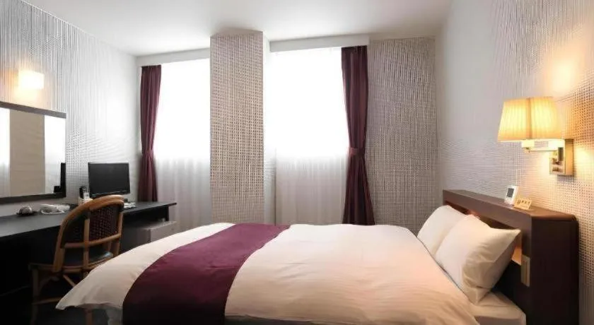 Bed in AKISAWA HOTEL