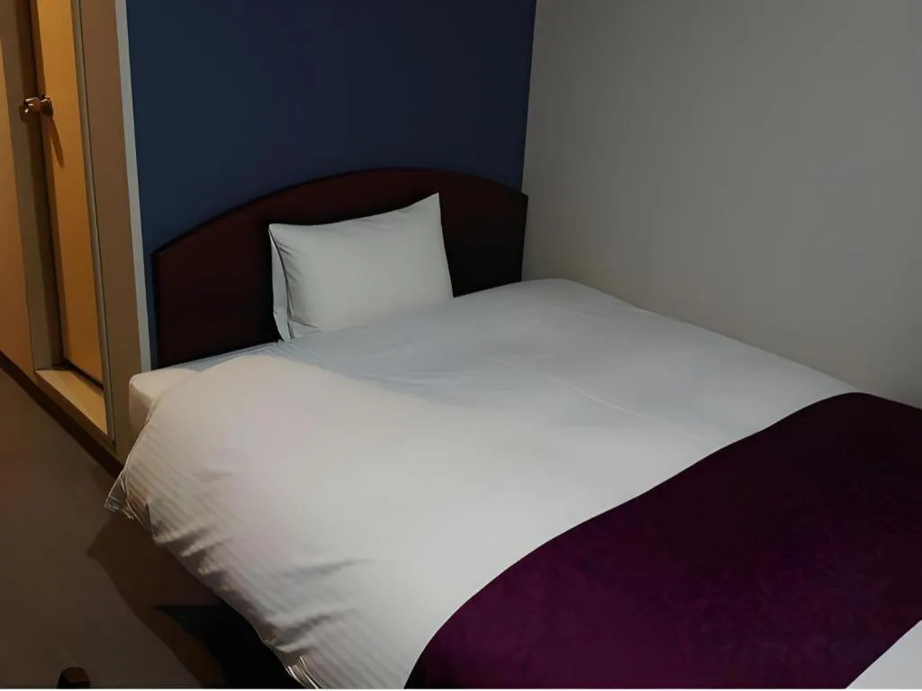 Bed in AKISAWA HOTEL