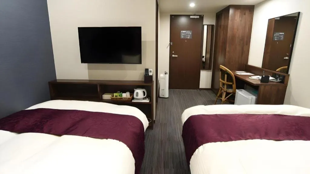 Bed in AKISAWA HOTEL