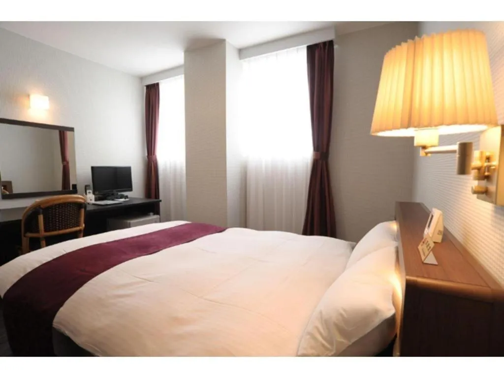 Bed in AKISAWA HOTEL