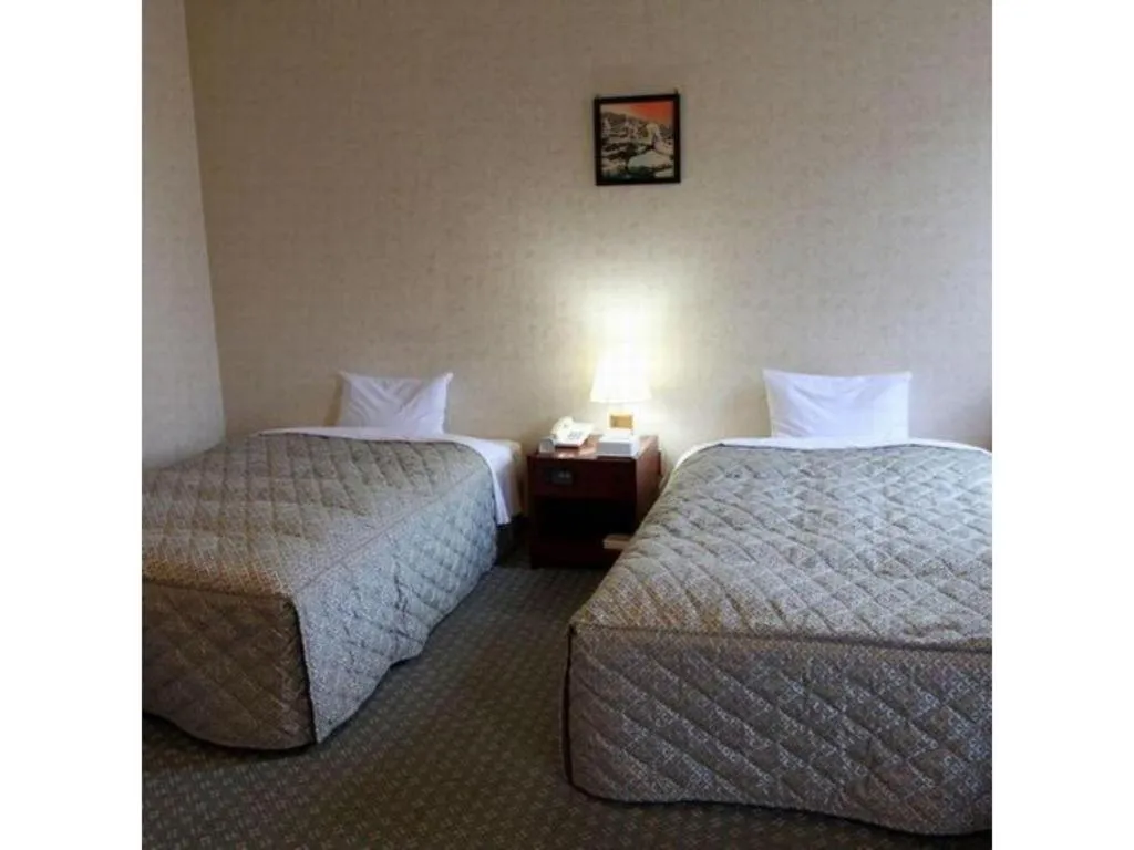 Bed in AKISAWA HOTEL